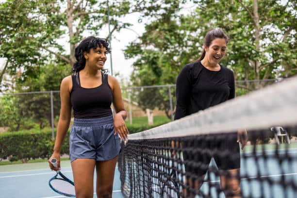 La'bel Balagne : A Young Black Woman And Her Friend Playing Tennis